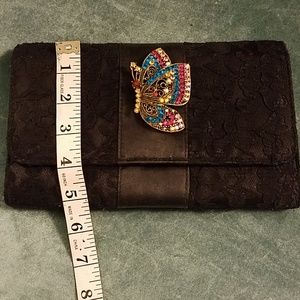 Black clutch with butterfly pin